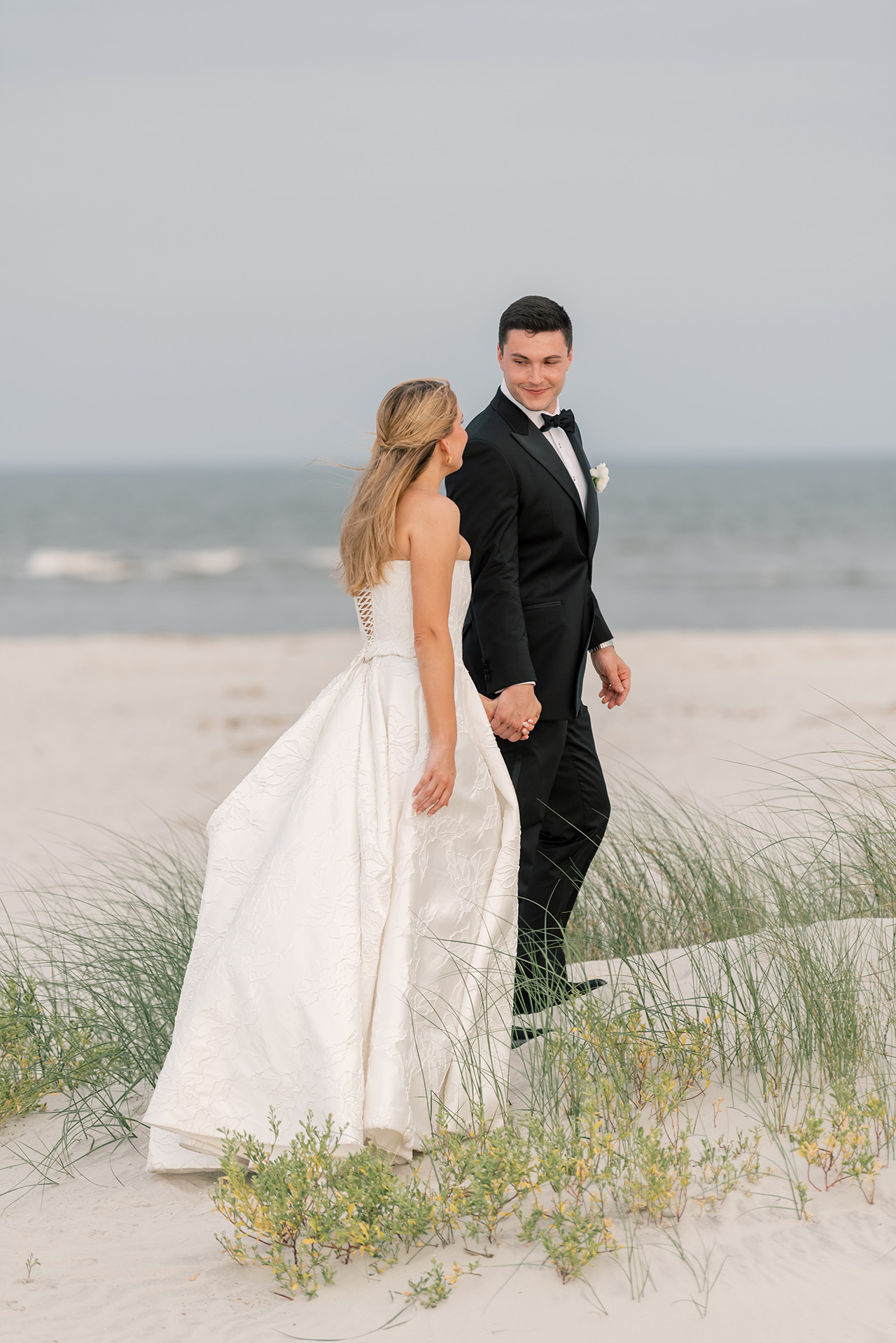 bride & groom on the beach in front of King & Prince