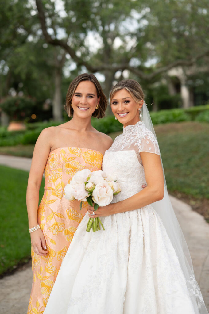 A Sea Island bride with her bridesmaids at the Cloister. The bridesmaids are wearing citrus-inspired, colorful gowns.