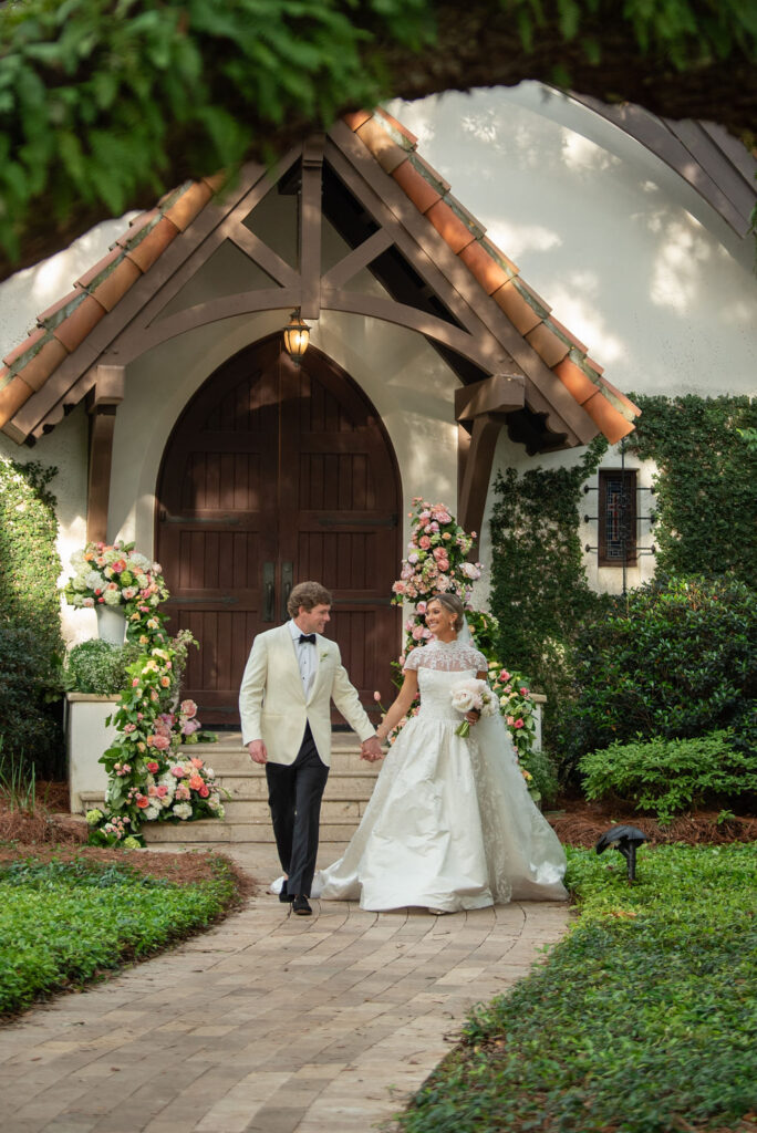 A Sea Island bride and groom walking away from the chapel at the Cloister.