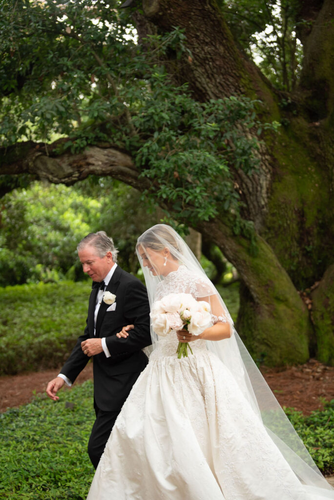 A Sea Island wedding, the father of the bride is walking her down the aisle to the Cloister Chapel.