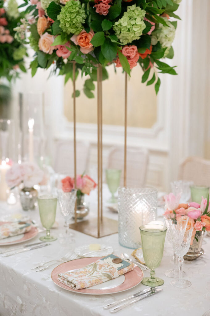 Reception details at a Sea Island wedding reception. Including vibrant florals and colorful place settings.