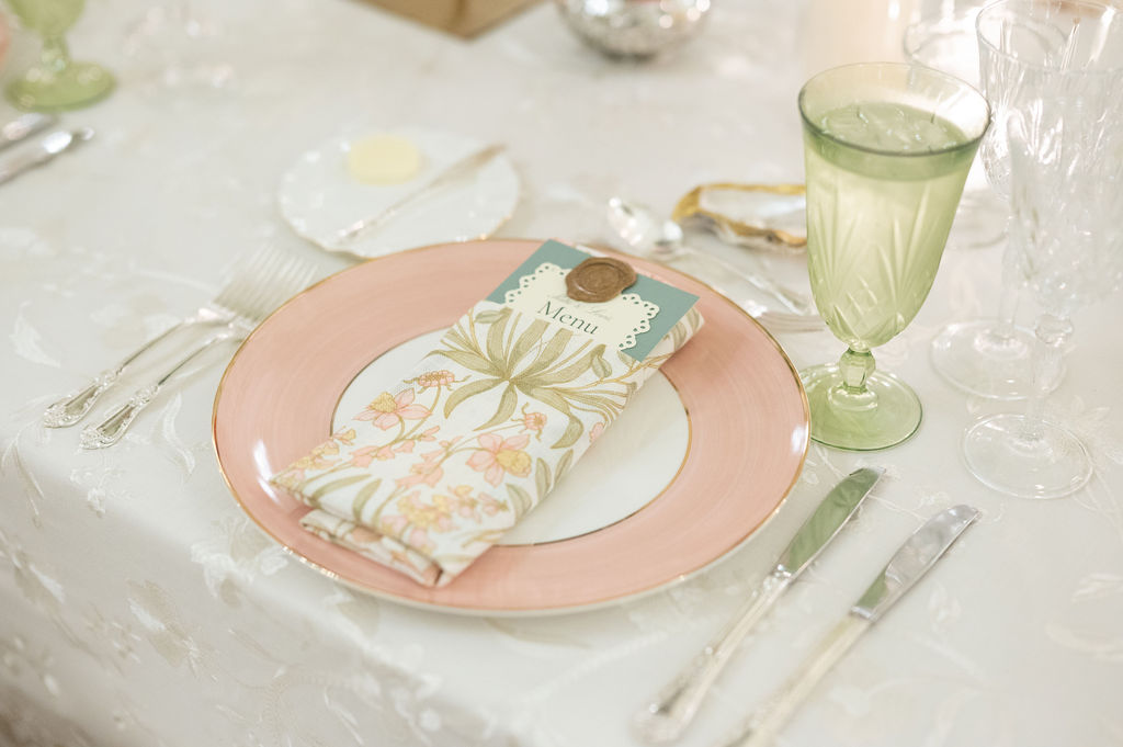 Reception details at a Sea Island wedding reception. Including vibrant florals and colorful place settings.